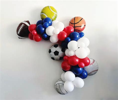 Balloons And Sports Balls Are Arranged In The Shape Of A Football