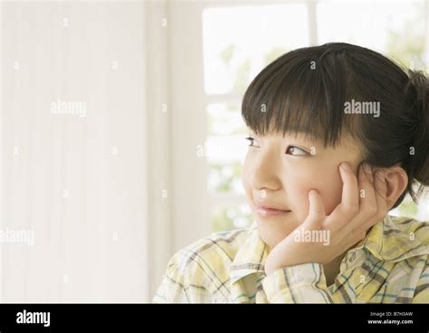 Smiling Girl Resting Her Cheek On Her Hand Stock Photo Alamy