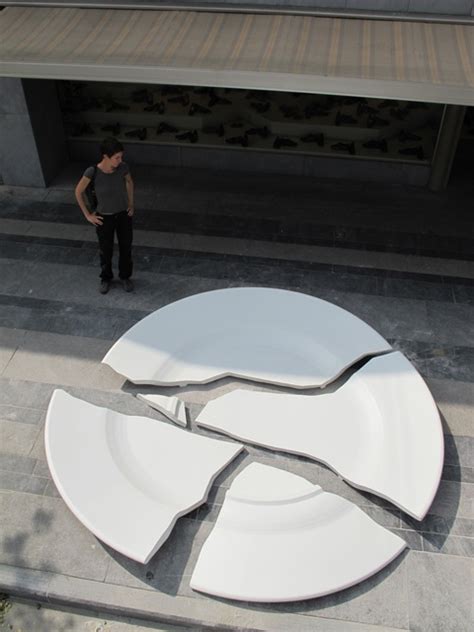 A Man Standing Next To A Large White Object