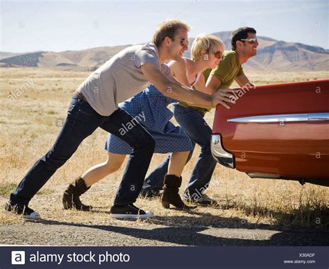 Three People Pushing Car High Resolution Stock Photography And Images