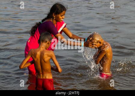 Indian Woman Bathing His Son At Tungabhadra River Hampi Karnataka