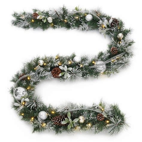 A simple fireplace decoration for the best time of the year. 9 ft. Battery Operated Snowy Silver Pine Artificial ...