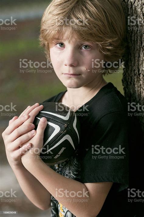 Boy Crying Holding A Football Stock Photo Download Image Now 8 9