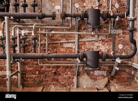 Old Heating System Of An Industrial Building With Many Pipes And