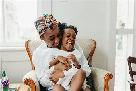 a mother giving her daughter a big hug and squeeze by stocksy contributor kristen curette