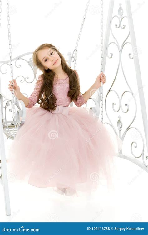 Charming Long Haired Girl In Nice Dress Swinging On Elegant Swing