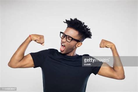 African American Man Flexing Biceps Photos And Premium High Res