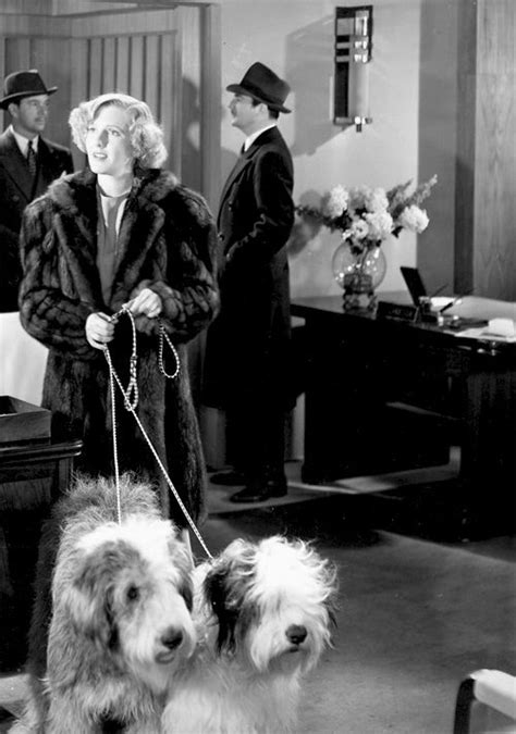 An Old Black And White Photo Of Two Dogs Being Walked By A Woman In A