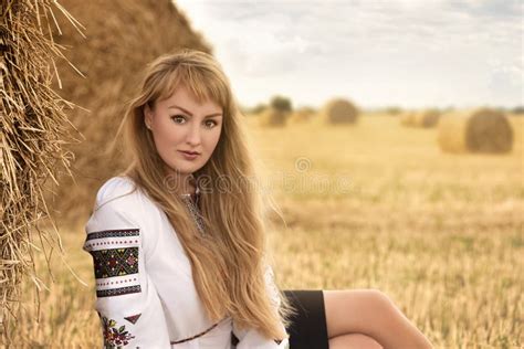 Girl With Long Hair In Ukrainian Clother Posing Among The Bales In The