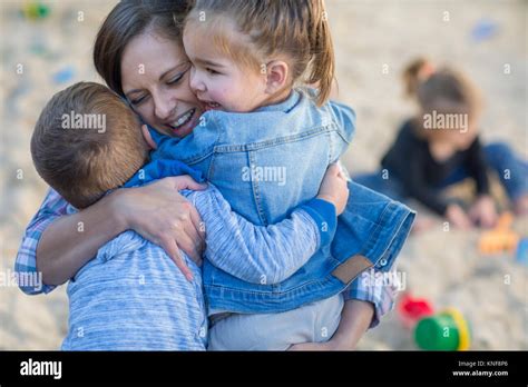 Mid Adult Woman Hugging Two Young Children Stock Photo Alamy