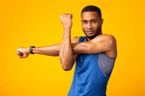 Healthy Black Guy Stretching Hand And Shoulder Before Workout Stock