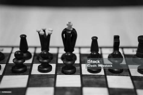 Grayscale Shot Of A Chessboard With The Focus On Blacks King Queen And