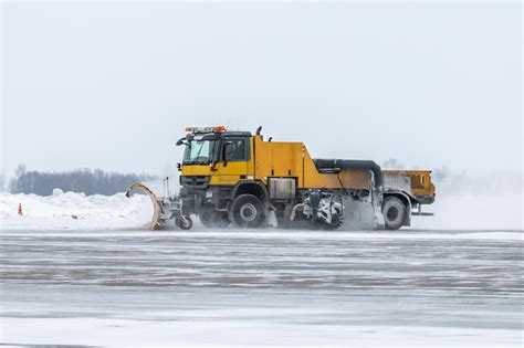 Premium Photo Snowblower Cleans Airport Apron In A Snowstorm