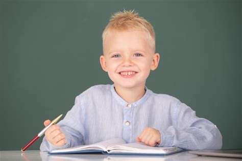 Premium Photo Kid Writing In Notebook In Class Little Schoolboy Study
