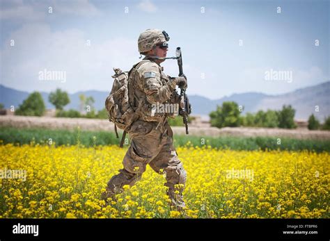 A Us Army Paratrooper With The 82nd Airborne Division Walks Through A