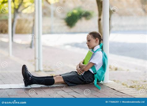 Thoughtful Schoolgirl Sitting Alone In Corridor Stock Image Image Of