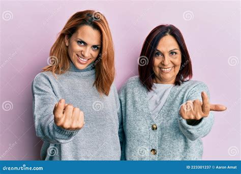 Latin Mother And Daughter Wearing Casual Clothes Beckoning Come Here Gesture With Hand Inviting