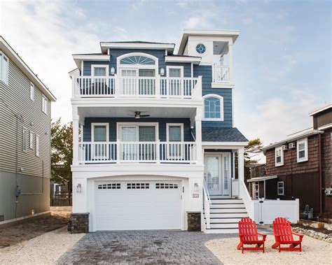 Purposeful, affordable, coastal cottage home plans. Narrow Lot Beach Home - Unique Beach Style Design by ...