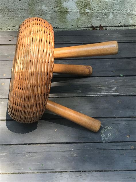 A small, low stool, usually upholstered, either for resting one's feet when sitting or sometimes used as individual seats. Mid-Century Modern Tony Paul Woven Rattan Wicker Round ...