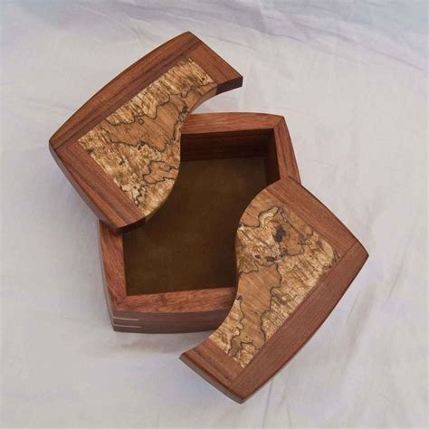 Three Wooden Boxes Sitting On Top Of A White Sheet Covered Floor With