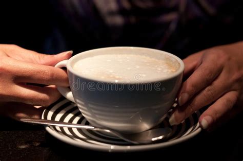 Frothy Coffee Hot Drink In Cup Being Held By Hands Stock Photo Image