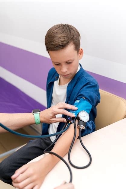 Premium Photo Pediatrician Is Measuring Blood Pressure Of Boy