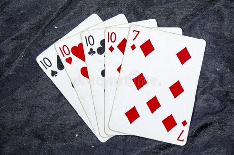 Five Playing Cards Four Of A Kind Ten S And A Seven Stock Photo