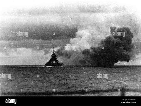 View Of The German Battleship Bismarck Firing On British Naval Forces