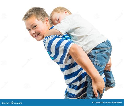 Loving Big Brother Carries Little Brother On His Back Stock Photo