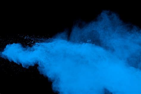 Premium Photo Blue Dust Explosion On Black Background