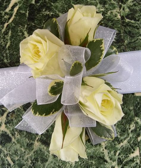 Soft Yellow Prom Corsage With Pale Yellow Spray Roses And White Ribbon
