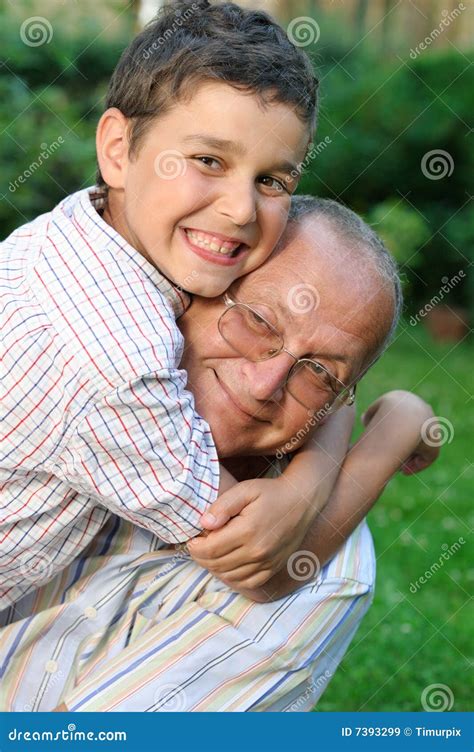 Happy Grandfather And Little Grandson Touching Noses Expressing Love