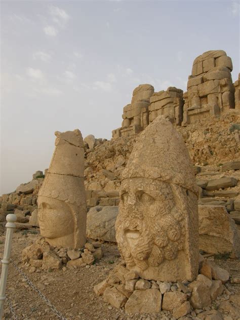 Two Stone Statues In The Middle Of A Rocky Area