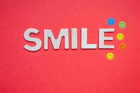 Premium Photo Smile Wooden Letters On The Red Background