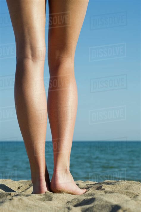 Babe Woman Standing On Beach Close Up Of Bare Legs Stock Photo Dissolve