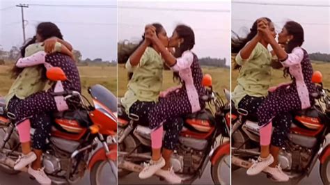 Watch 2 Girls Facing Each Other On Moving Bike Hug And Kiss In Viral