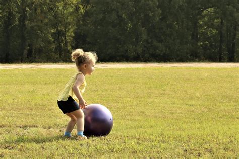 Little Girl Rolling Big Ball Free Stock Photo Public Domain Pictures
