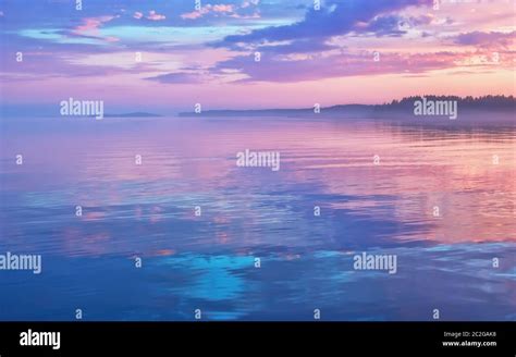 Misty Seascape Calm Water Surface Of The Lake Reflects Lilac Sky With