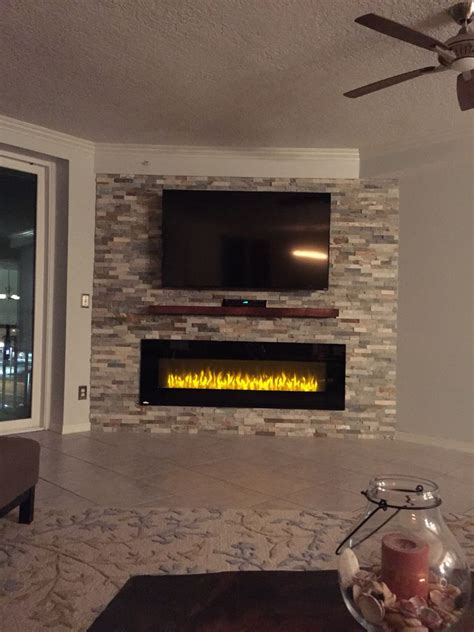 This Stone Wall And Electric Fireplace Give This Living Space At The Beach A Wonderful Ambian