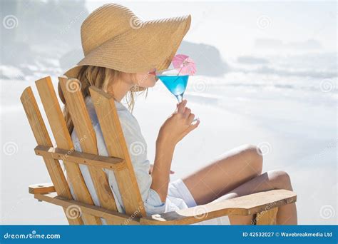 Smiling Blonde Relaxing In Deck Chair By The Sea Sipping Cocktail Stock Image Image Of View