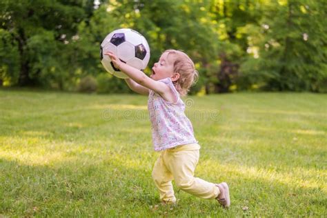 Little Child Is Playing With Football Ball In Park Stock Image Image