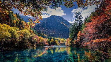 Lake Between Red And Green Leafed Trees With Long View Of