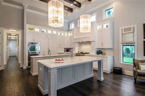 Two islands and a balance of light and dark colors help this remodeled kitchen fit neatly into a large space. 20+ Kitchens with Two Islands - Home Awakening