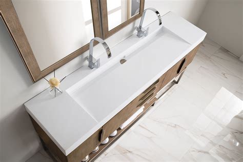 A Bathroom Sink With Two Mirrors Above It And Marble Flooring In Front