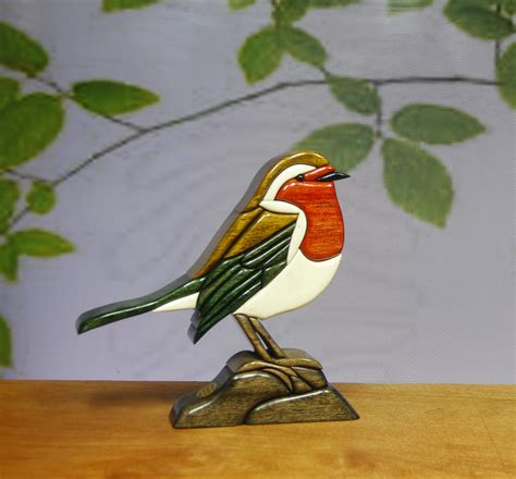 A Small Bird Sitting On Top Of A Wooden Table