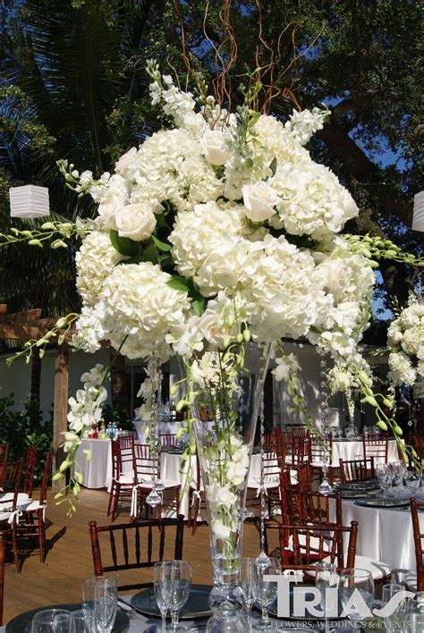 Tall Centerpiece With White Hydrangeas Roses And Orchids