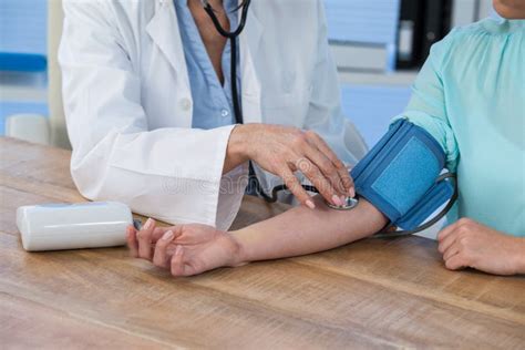 Female Doctor Checking Blood Pressure Of A Patient Stock Image Image