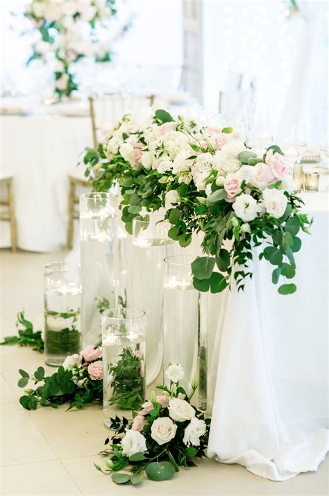 Romantic Sweetheart Table With Cascading Flowers And Greenery And