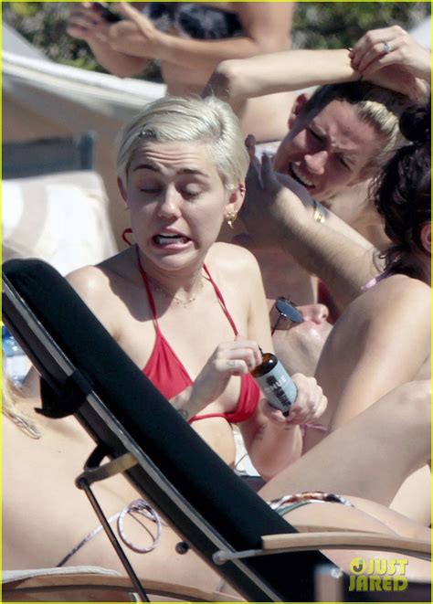 miley cyrus displays her amazing bikini body douses herself with water while hanging poolside