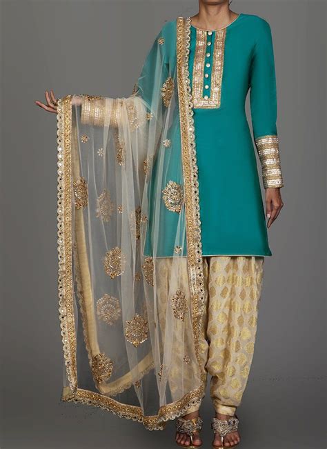 Teal And Golden Cream Brocade Punjabi Suit Features A Taffeta Silk Kameez With Santoon Inner